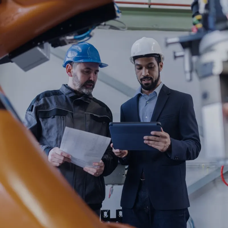 Employees of a company reviewing production costs. Employees of a company reviewing production costs.